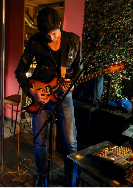 Houssam performing electric guitar live